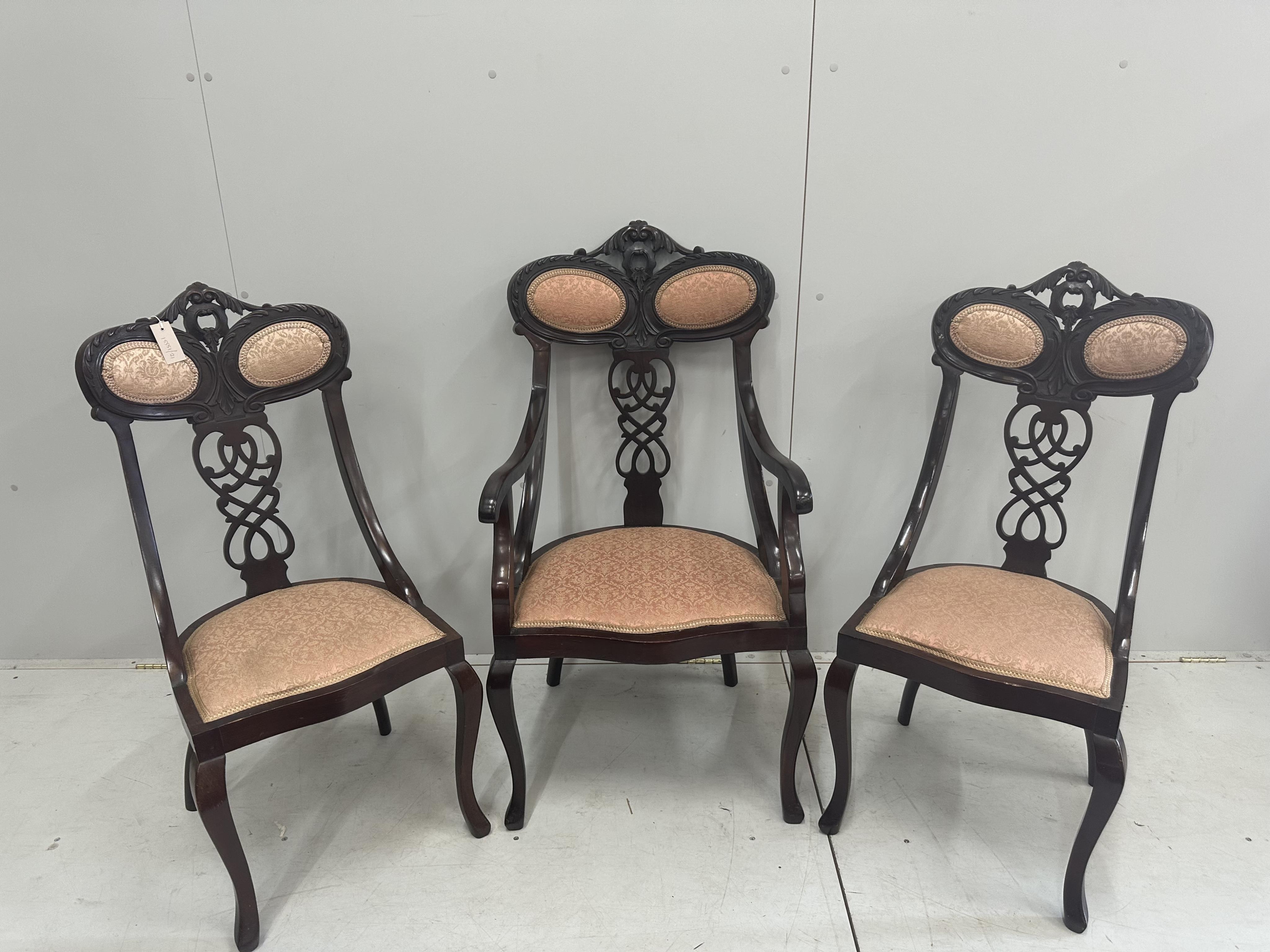 A late Victorian carved mahogany seven piece salon suite, settee width 120cm, depth 50cm, height 105cm. Condition - fair to good